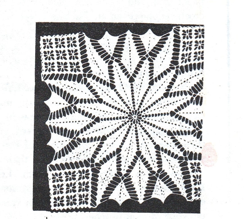 May include: A detailed, white crochet doily with a starburst design. The center radiates outward with pointed segments, surrounded by a scalloped edge. Small floral patterns fill the corners, creating a delicate, handmade aesthetic. The doily is set against a black background.
