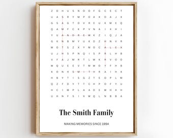 May include: Framed word search art print with a wooden frame. The print features a word search puzzle with the words "The Smith Family" at the bottom, and "MAKING MEMORIES SINCE 1994" below it. The background is white.