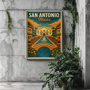 May include: A framed San Antonio, Texas art print. The artwork features a colorful illustration of the Alamo, a bridge over a river, and buildings with umbrellas. The text "SAN ANTONIO Texas" is at the top of the print.