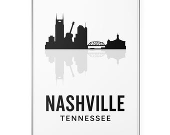 May include: A framed print featuring the Nashville, Tennessee skyline in black silhouette against a white background. The print includes the city's name and state in bold, black text.
