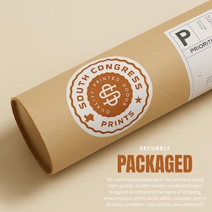 May include: A brown cardboard tube with a white and brown sticker that reads "South Congress Printed Goods Prints." The tube is labeled "Priority" and "Packaged" in large letters. The packaging is designed to protect the contents during shipping.