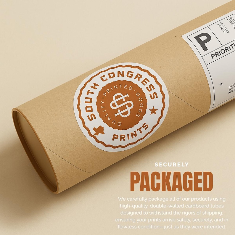 May include: A brown cardboard tube with a white and brown sticker that reads "South Congress Printed Goods Prints." The tube is labeled "Priority" and "Packaged" in large letters. The packaging is designed to protect the contents during shipping.