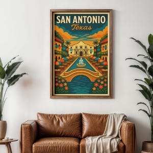 May include: A framed vintage-style travel poster of San Antonio, Texas, featuring the Alamo, a bridge over a canal, and colorful umbrellas. The poster has a warm color palette with the text "SAN ANTONIO Texas" at the top.