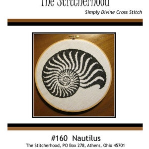 May include: Black and white cross stitch pattern of a nautilus shell in a wooden embroidery hoop. The pattern is titled "#160 Nautilus" and is from The Stitcherhood, PO Box 278, Athens, Ohio 45701. The website is www.thestitcherhood.com.