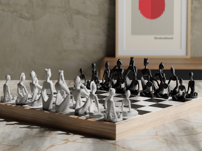 May include: A modern chess set with black and white pieces on a checkered board. The chess pieces are stylized human figures. The board is set on a wooden base. A framed artwork is in the background.