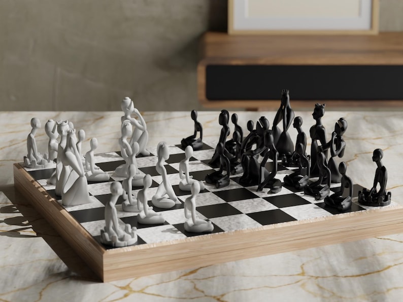 May include: A unique chess set with abstract, human-like figures. The pieces are split into two teams, white and black, and are arranged on a checkered board. The board is set on a wooden base, creating a modern aesthetic.
