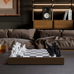 May include: A modern chess set with white and black pieces, each shaped like stylized human figures, arranged on a checkered board. The board is set on a brown wooden base, placed on a dark table. The background includes a sofa and shelves.