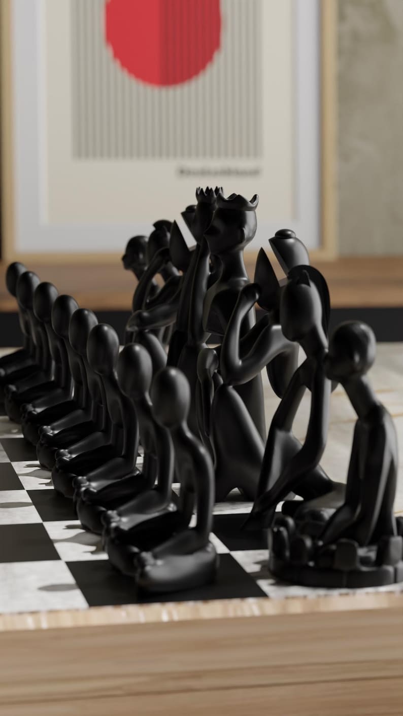 May include: A black chess set with uniquely designed pieces. The pieces are stylized human figures in various poses, set on a black and white checkered board. The background includes a framed artwork with a red circle.