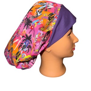 May include: A pink and orange patterned scrub cap with a purple band. The cap features a design of palm trees and figures in a comic book style. The cap is on a mannequin head.