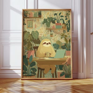 May include: A framed art print featuring a cartoon sloth sitting at a desk with a laptop and a mug, surrounded by potted plants. The artwork has a warm color palette with a detailed background of more plants and shelves.