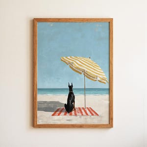 May include: A framed art print depicts a black Doberman Pinscher sitting on a red and white striped beach towel, gazing at the ocean. A yellow and white striped beach umbrella provides shade. The background features a blue sky and ocean.