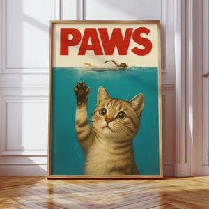 May include: A poster with the word "PAWS" in red letters on a white background. A cat with brown and white fur is reaching up with its paw from a blue background. The cat is looking up with a surprised expression.