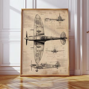 May include: A framed vintage-style blueprint of a Spitfire airplane. The black and white technical drawings show the aircraft from multiple angles, including top, side, and front views. The print is set against a tan background and framed in a light brown wooden frame.