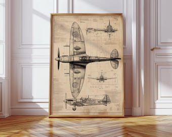 May include: A framed vintage-style blueprint of a Spitfire airplane. The black and white technical drawings show the aircraft from multiple angles, including top, side, and front views. The print is set against a tan background and framed in a light brown wooden frame.