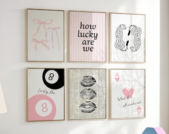 May include: Six framed art prints with gold frames. The prints feature various designs, including pink bows, the text "how lucky are we", black and white cheetahs, a pink and black 8-ball, lips, and a heart with the text "What if it all works out".