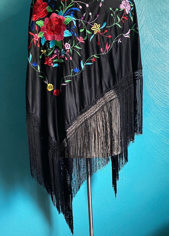 Black shawl with large floral embroidery.