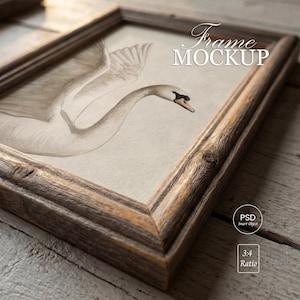 May include: A framed watercolor print featuring a swan with outstretched wings. The artwork is set within a rustic, weathered wooden frame. The words "Frame Mockup" are displayed in elegant script. The frame has a 3:4 ratio.