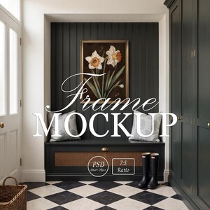 May include: A rectangular gold-toned frame containing a botanical print of white and orange daffodils, centred above a black bench with cane detailing, two patterned throw pillows, and black rubber boots on a black and white chequered floor.