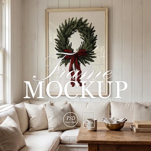 May include: A rectangular light-colored wooden frame containing a print of a green pine wreath with a dark red velvet bow. The text "Frame MOCKUP" is overlaid in white, along with circular "PSD Smart Object" and "5:7 Ratio" icons.
