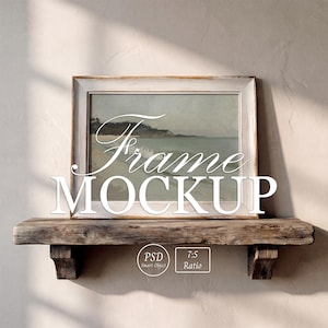May include: A white distressed wooden picture frame containing a landscape painting of a beach scene. The frame sits on a rustic wooden shelf. The text "Frame MOCKUP" is overlaid in white, along with small circular and rectangular labels reading "PSD Smart Object" and "7:5 Ratio".