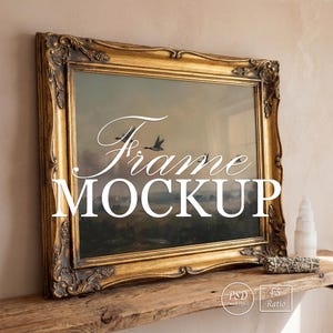 May include: A gold ornate picture frame with a landscape painting. The frame has intricate detailing and the text "Frame MOCKUP" is overlaid on the image. The frame is resting on a wooden shelf with decorative items.