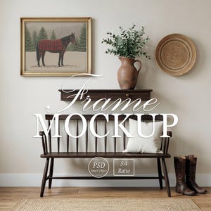 May include: A framed horse painting with a red plaid blanket hangs above a dark wood bench with a white pillow. A brown vase with greenery, a woven plate, and tall brown boots complete the rustic scene. The word "Frame MOCKUP" is displayed.