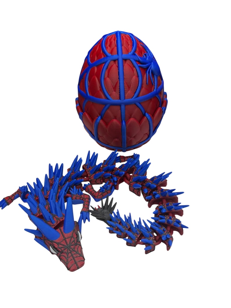 May include: A red and blue 3D-printed egg-shaped object with a web-like design and a blue spider. Below, a red and blue dragon with spiky details and a webbed face.