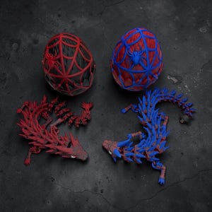 May include: Two decorative eggs and two articulated dragon figures. One egg is red and black with a spiderweb design and a spider. The other egg is red and blue with a spiderweb design and a spider. The dragons are red and blue.