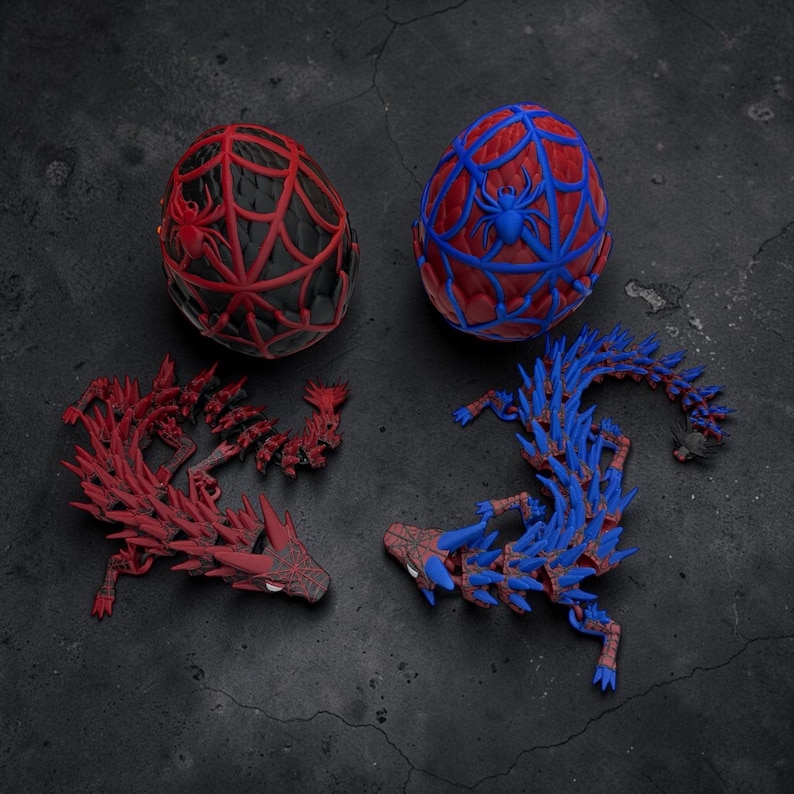 May include: Two decorative eggs and two articulated dragon figures. One egg is red and black with a spiderweb design and a spider. The other egg is red and blue with a spiderweb design and a spider. The dragons are red and blue.