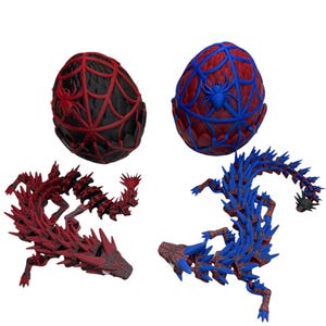 May include: Two decorative dragon sculptures and two egg-shaped ornaments. One dragon is red, the other is blue. The eggs are red and blue with spiderweb and spider designs. The items are 3D printed.