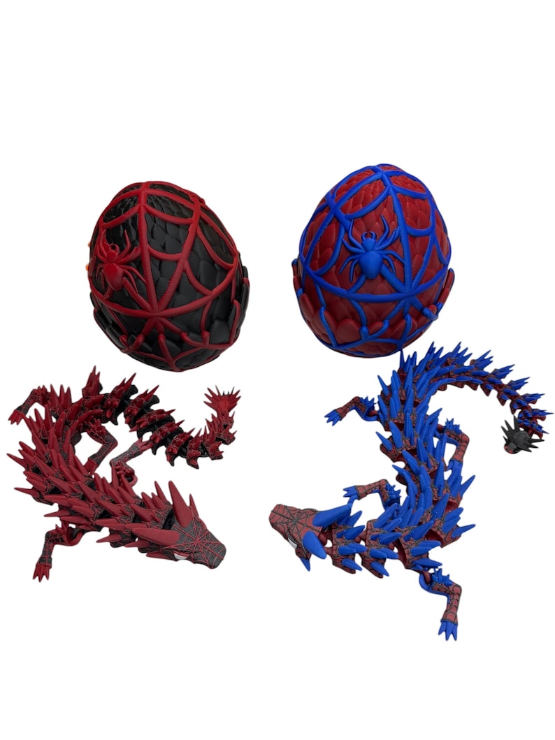 May include: Two decorative dragon sculptures and two egg-shaped ornaments. One dragon is red, the other is blue. The eggs are red and blue with spiderweb and spider designs. The items are 3D printed.