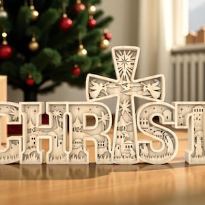 May include: Wooden Christmas decoration spelling out "CHRIST" with a cross design. The letters are intricately carved with scenes of the Nativity. A Christmas tree with red and gold ornaments and a wrapped gift are in the background.