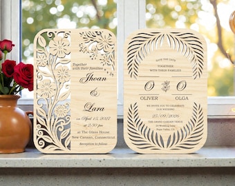 May include: Two wooden wedding invitations with floral and leaf cutouts. One features the names Jhoan & Lara and the date April 15, 2027. The other says "Save the Date" and lists the names Oliver & Olga and the date September 25, 2026.