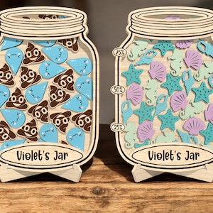 May include: Two wooden jar-shaped decorations. One jar features brown poop and blue water drop shapes, the other has purple, teal, and green seashell shapes. Both jars have the text "Violet's Jar".