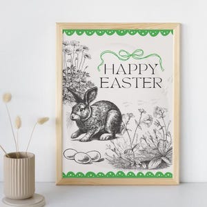 May include: A printable sign with a green border and a white background. The sign features a black and white illustration of a rabbit with three eggs and the text "Happy Easter".