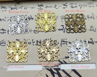 May include: Six square metal filigree connectors with floral patterns, labeled as Rhodium Plated, Raw Brass, Antique Bronze, Gold Plated, KC Gold Plated, and Silver Plated. Each piece features a symmetrical, openwork design with a central flower.