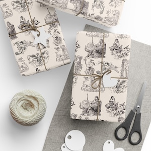 May include: Several gift-wrapped parcels with cream-coloured paper printed with black illustrations of classical figures and angels. The parcels are tied with twine and have blank tags. A ball of twine, scissors, and blank tags are also visible.