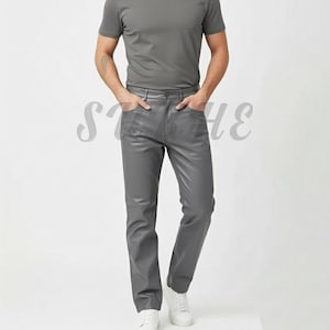 May include: A person wearing a gray crew neck t-shirt and gray leather-look pants. The pants have a classic five-pocket design. The person is wearing white sneakers. The outfit is monochromatic and casual.
