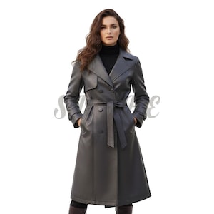 May include: A dark grey leather trench coat featuring a double-breasted design, a belt at the waist, and a classic collar. The coat is knee-length and has pockets. The model is wearing a black turtleneck.