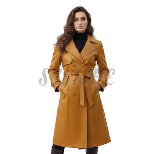 May include: A long, mustard-coloured trench coat with a belted waist and double-breasted front. The coat features a classic lapel collar and button details. The model is wearing a black turtleneck underneath.
