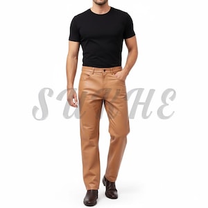 May include: Tan leather trousers with a classic five-pocket design. The trousers have a straight leg cut and a button and zip closure. The model is wearing a black crew neck t-shirt and brown leather shoes.