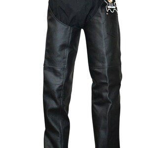 May include: Black leather chaps with a belt and buckle closure. The chaps have a black fabric upper section and a leather lower section. A tag with the words "Genuine Leather" is attached to the right side.