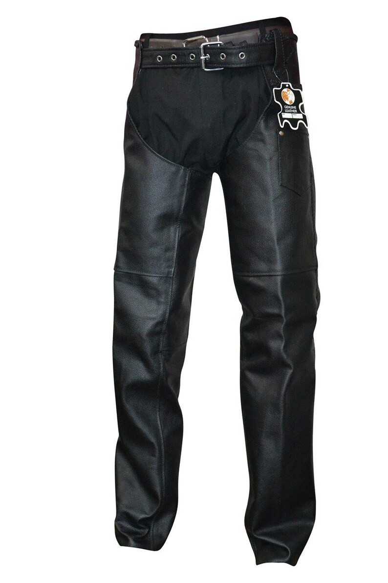 May include: Black leather chaps with a belt and buckle closure. The chaps have a black fabric upper section and a leather lower section. A tag with the words "Genuine Leather" is attached to the right side.