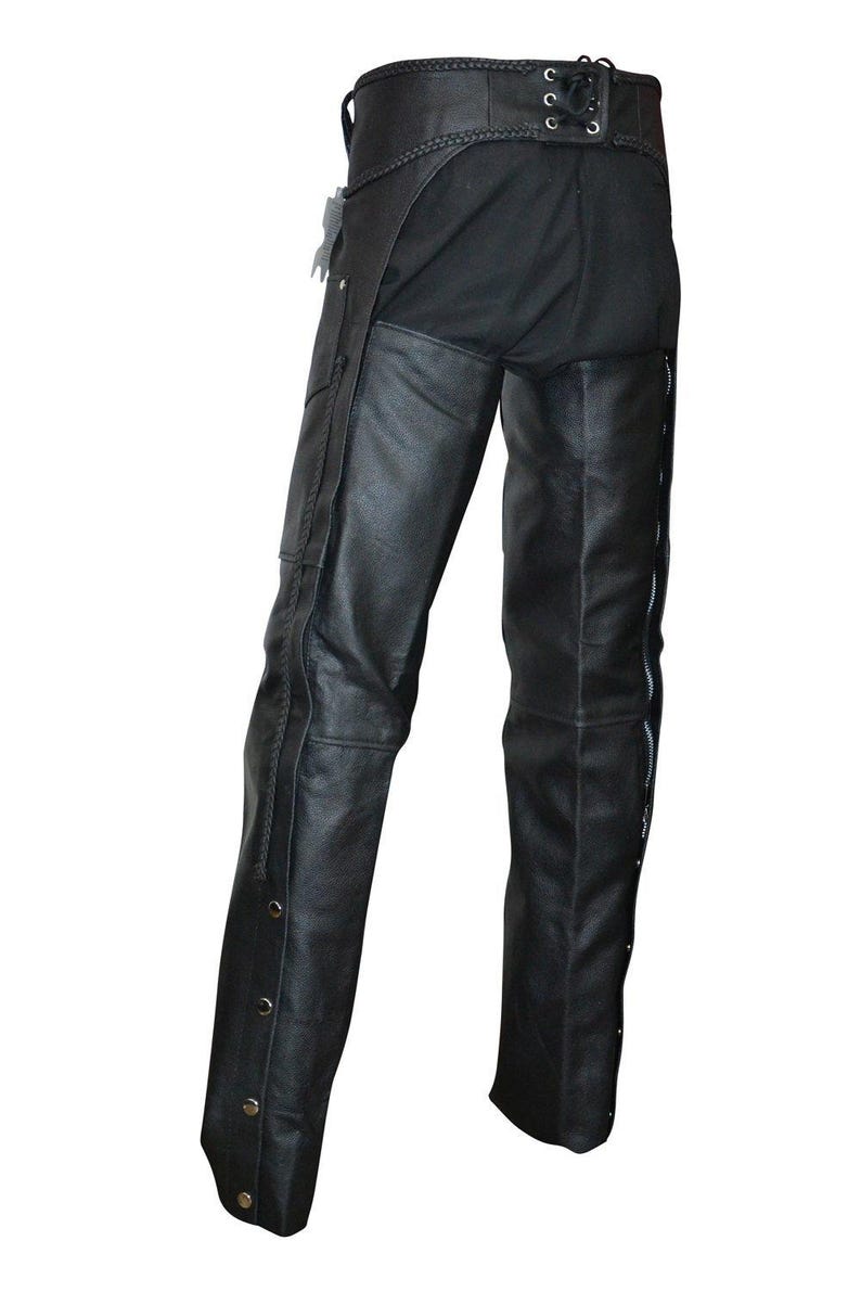 May include: Black leather chaps with a braided waistband and lace-up detail at the back. The chaps feature side zippers and decorative snaps along the outer leg seams. A classic biker style.