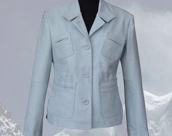 May include: A pale blue blazer with a notched collar, two chest pockets, and two lower pockets. The jacket has a three-button closure and long sleeves. The blazer is displayed on a black mannequin.