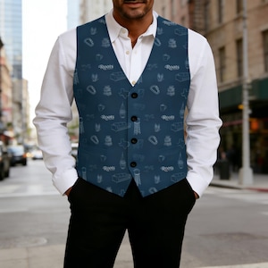 May include: A navy blue vest with a white pattern of various icons, including a sofa, a coffee cup, and the word "Roots". The vest has a button-up front and is worn over a white dress shirt.