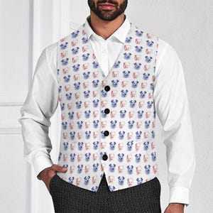 May include: A white vest with a repeating pattern of dog faces in red and blue. The vest has a button-up front and is worn over a white collared shirt. The vest is part of a formal outfit.