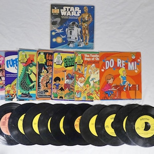 May include: A collection of vintage children's vinyl records and illustrated storybook sleeves. Titles include Star Wars, Romper Room, Puff the Magic Dragon, Sesame Street, The Twelve Days of Christmas, and Do Re Mi, featuring colorful character artwork.