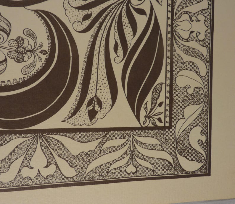 May include: Close-up of a decorative artwork featuring a repeating pattern of brown floral and leaf motifs on a beige background. The design includes intricate details and a border with stylized leaves and dots.