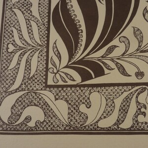 May include: A detailed illustration featuring a brown and cream color palette. The design showcases intricate floral and leaf patterns, with a border of small, square-like shapes. The artwork has a vintage aesthetic, with a focus on decorative elements.